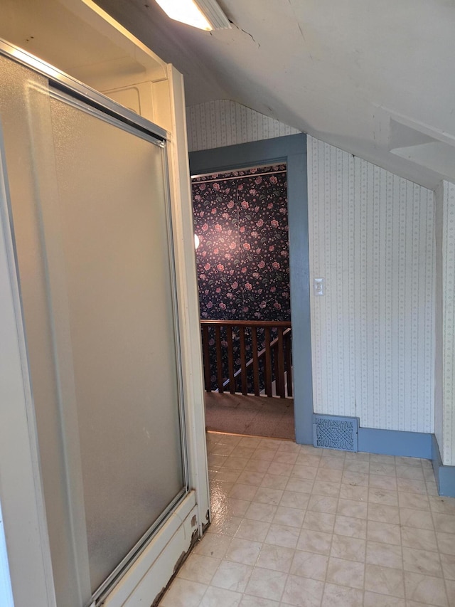 505 N Pine St, Evart, MI 49631 - wine area with wallpapered walls, vaulted ceiling, and light flooring