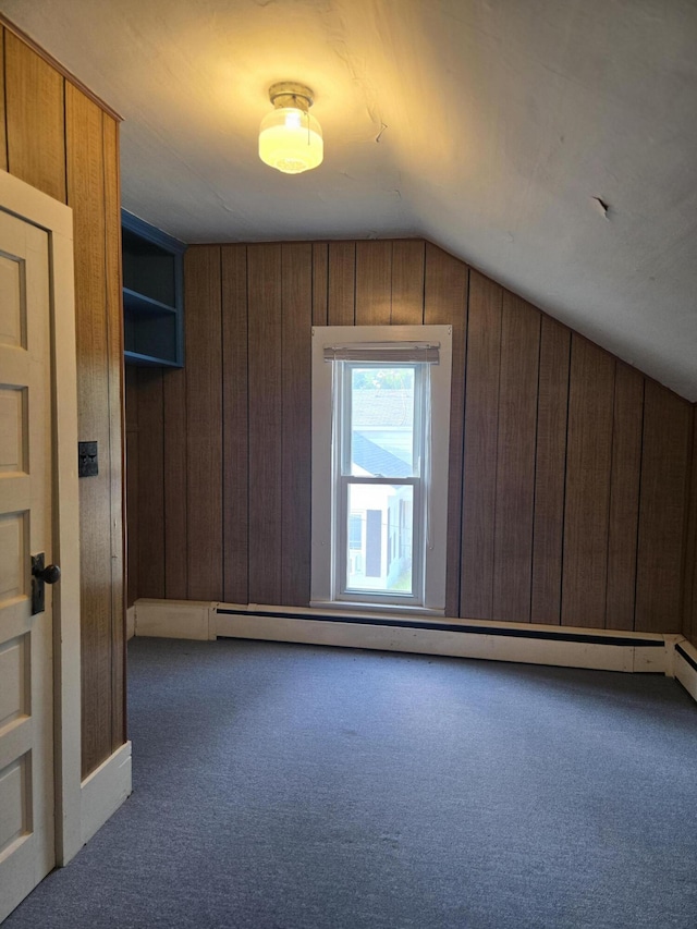 505 N Pine St, Evart, MI 49631 - additional living space featuring carpet flooring, vaulted ceiling, wood walls, and a baseboard heating unit