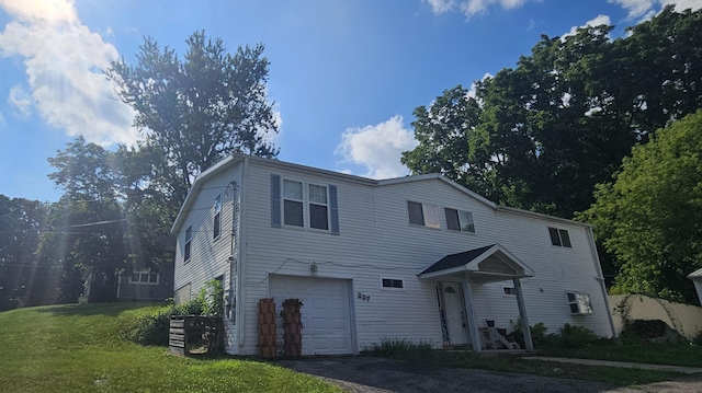 227 W Nelson St, Hastings, MI 49058 - traditional-style home with an attached garage, a front yard, and asphalt driveway