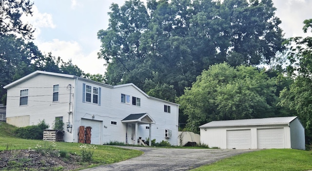 227 W Nelson St, Hastings, MI 49058 - view of front facade featuring an outbuilding, a front yard, and a detached garage