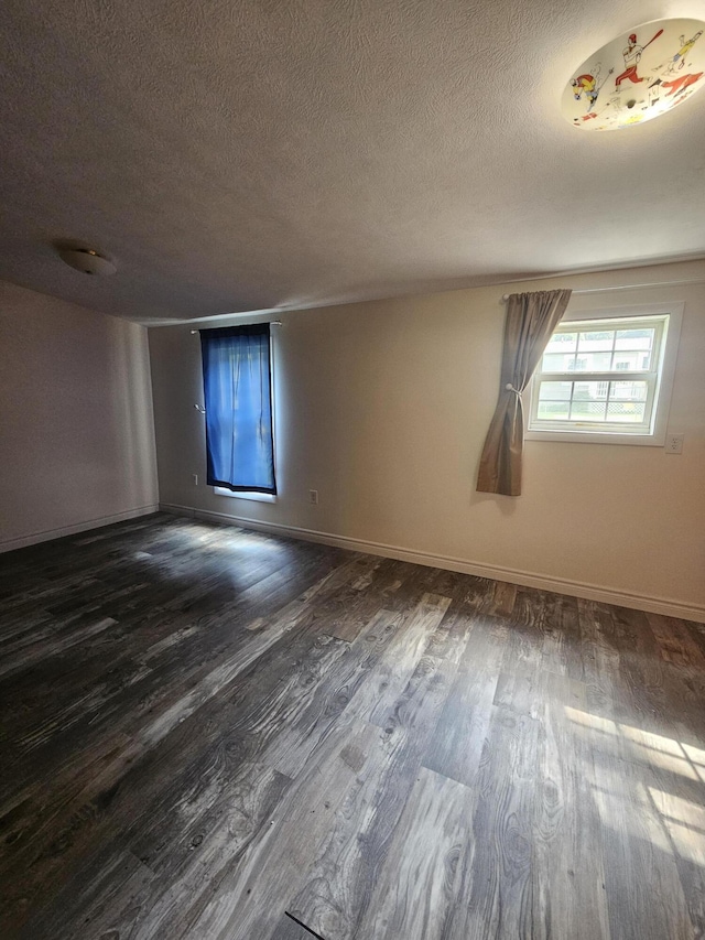 227 W Nelson St, Hastings, MI 49058 - spare room with dark wood-type flooring and a textured ceiling