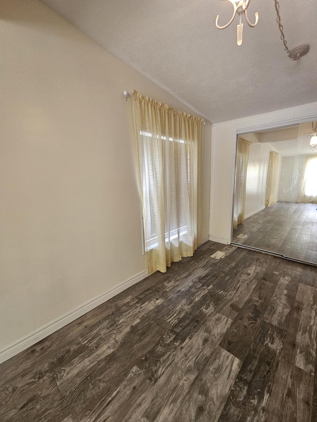 227 W Nelson St, Hastings, MI 49058 - unfurnished room with dark wood-type flooring and a chandelier