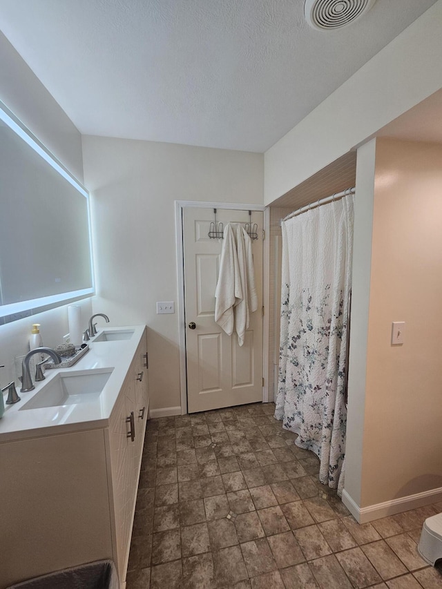 227 W Nelson St, Hastings, MI 49058 - full bath featuring double vanity, stone finish floors, and a shower with curtain