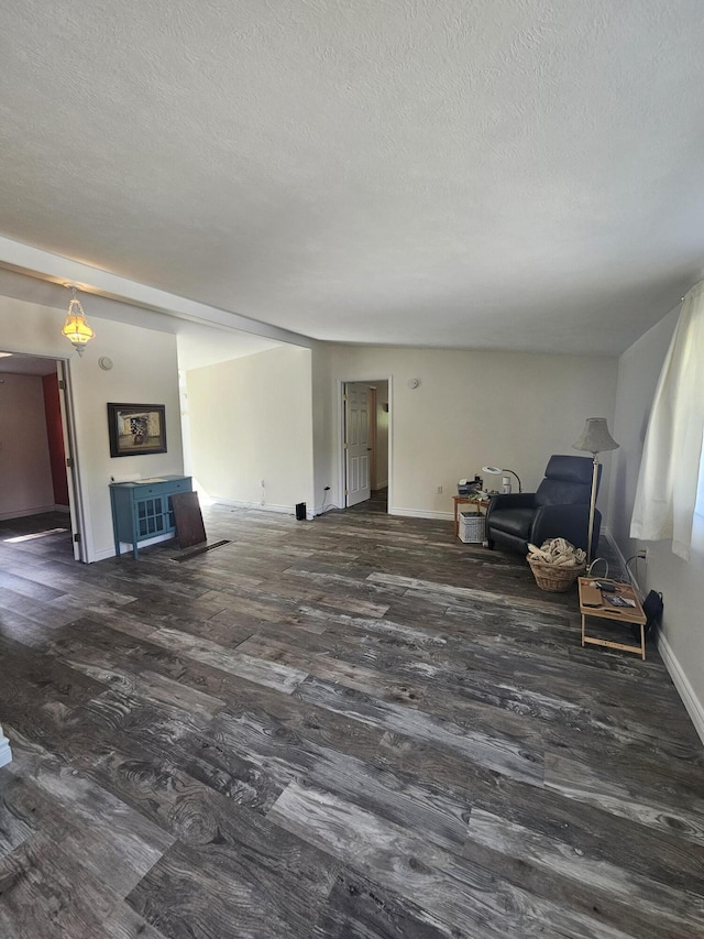 227 W Nelson St, Hastings, MI 49058 - unfurnished living room with a textured ceiling and wood finished floors