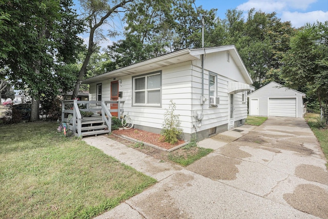 2620 Charlesgate Ave SW, Wyoming, MI 49509 - view of front facade featuring an outbuilding, a wooden deck, driveway, a front lawn, and a detached garage
