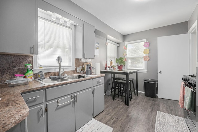 2620 Charlesgate Ave SW, Wyoming, MI 49509 - kitchen with range with gas cooktop, wood finished floors, healthy amount of natural light, and gray cabinetry