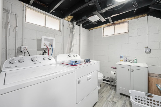2620 Charlesgate Ave SW, Wyoming, MI 49509 - laundry area featuring washer and clothes dryer, light wood-style flooring, and healthy amount of natural light
