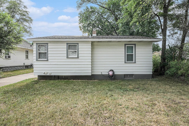 2620 Charlesgate Ave SW, Wyoming, MI 49509 - view of home's exterior featuring a yard and a chimney