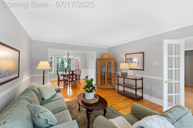 455 Leicester St, Plymouth, MI 48170 - living area featuring a chandelier, wood finished floors, and ornamental molding