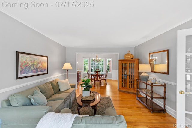 455 Leicester St, Plymouth, MI 48170 - living room with a chandelier, light wood-style flooring, and ornamental molding