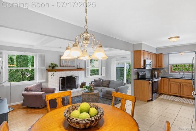 455 Leicester St, Plymouth, MI 48170 - dining space with a brick fireplace, a chandelier, light tile patterned floors, and beamed ceiling