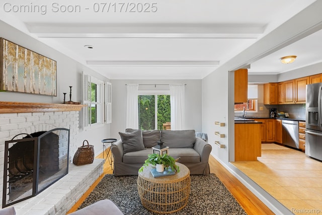 455 Leicester St, Plymouth, MI 48170 - living room with beam ceiling, light wood finished floors, and a brick fireplace