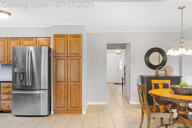 455 Leicester St, Plymouth, MI 48170 - kitchen featuring stainless steel fridge, a chandelier, brown cabinetry, light tile patterned floors, and ornamental molding