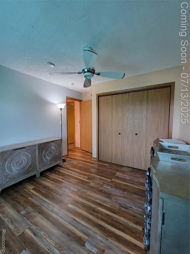 14373 Racho Blvd, Taylor, MI 48180 - bedroom featuring dark wood-style flooring, a textured ceiling, a closet, and a ceiling fan