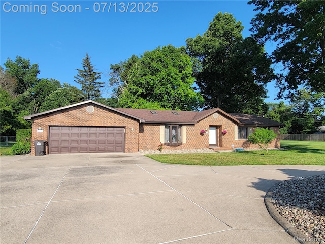 14373 Racho Blvd, Taylor, MI 48180 - single story home featuring concrete driveway, a garage, and brick siding