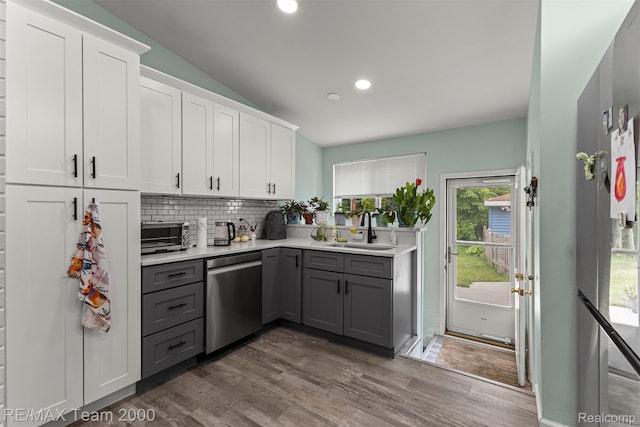 7396 N Charlesworth St, Dearborn Heights, MI 48127 - kitchen with stainless steel dishwasher, gray cabinetry, light countertops, dark wood-style flooring, and recessed lighting