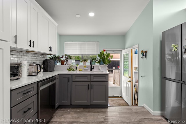 7396 N Charlesworth St, Dearborn Heights, MI 48127 - kitchen featuring appliances with stainless steel finishes, gray cabinetry, tasteful backsplash, white cabinetry, and light countertops