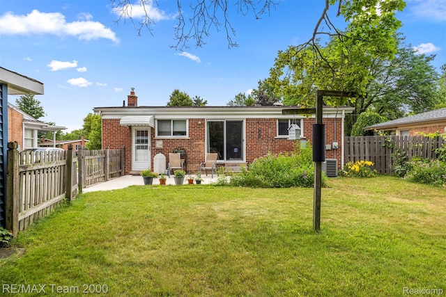 7396 N Charlesworth St, Dearborn Heights, MI 48127 - back of property with a chimney, a fenced backyard, and brick siding