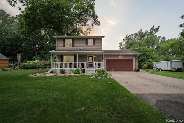 514 Sulley St, Waterford, MI 48327 - view of front of property with covered porch, driveway, an attached garage, and a lawn