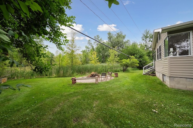 514 Sulley St, Waterford, MI 48327 - view of grassy yard with an outdoor fire pit