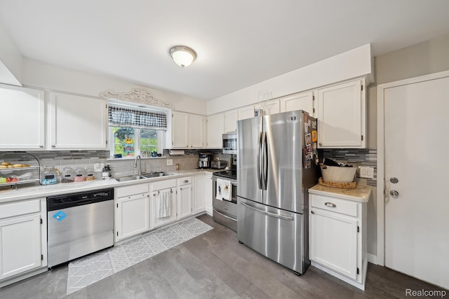 514 Sulley St, Waterford, MI 48327 - kitchen featuring stainless steel appliances, tasteful backsplash, light countertops, and white cabinetry