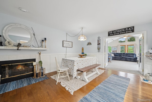 514 Sulley St, Waterford, MI 48327 - dining room featuring wood finished floors, a fireplace, a wainscoted wall, and ceiling fan