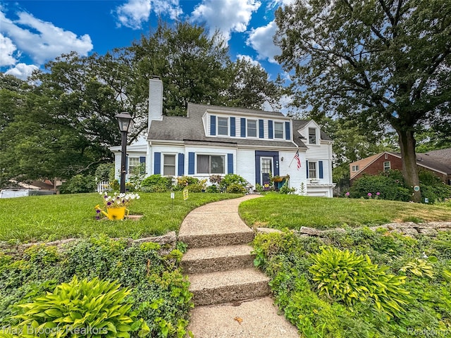 611 N Melborn St, Dearborn, MI 48128 - view of front of home with a chimney, a front lawn, and a shingled roof