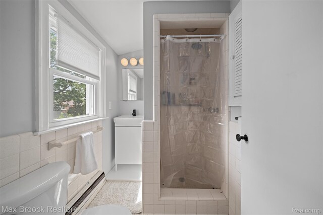 611 N Melborn St, Dearborn, MI 48128 - full bath with tile walls, vanity, a shower stall, and a baseboard radiator