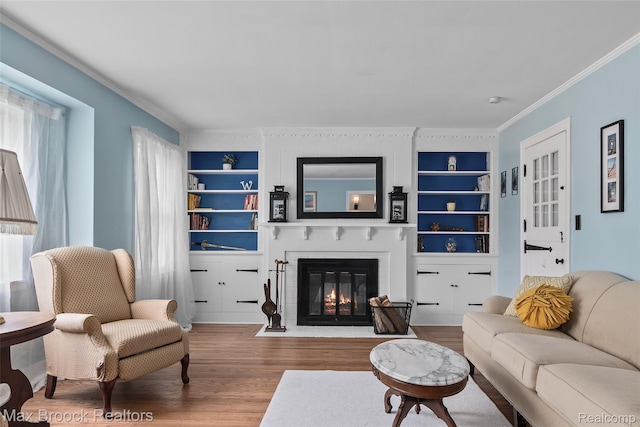 611 N Melborn St, Dearborn, MI 48128 - living area with built in shelves, crown molding, wood finished floors, and a fireplace