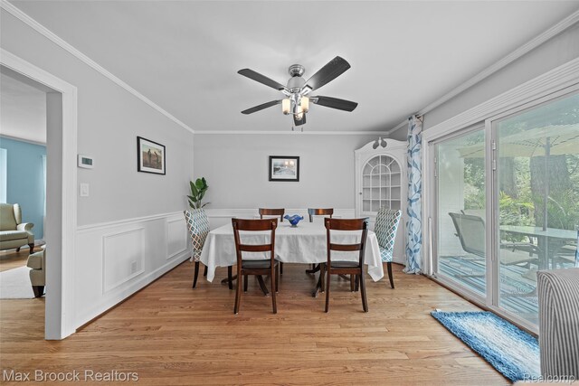 611 N Melborn St, Dearborn, MI 48128 - dining area featuring ornamental molding, light wood-type flooring, wainscoting, and ceiling fan