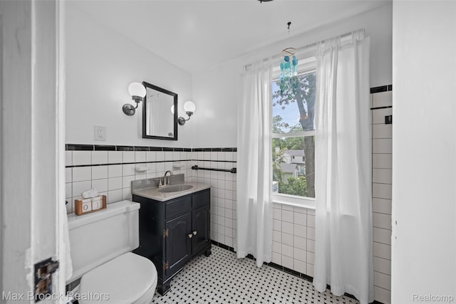 611 N Melborn St, Dearborn, MI 48128 - bathroom with tile walls, vanity, healthy amount of natural light, and wainscoting