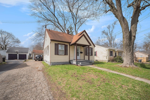 2820 Lowell St, Kalamazoo, MI 49001 - bungalow featuring an outdoor structure, a chimney, a front yard, a detached garage, and roof with shingles