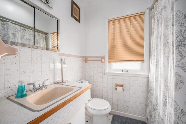 2820 Lowell St, Kalamazoo, MI 49001 - bathroom with vanity, tile walls, and a wainscoted wall