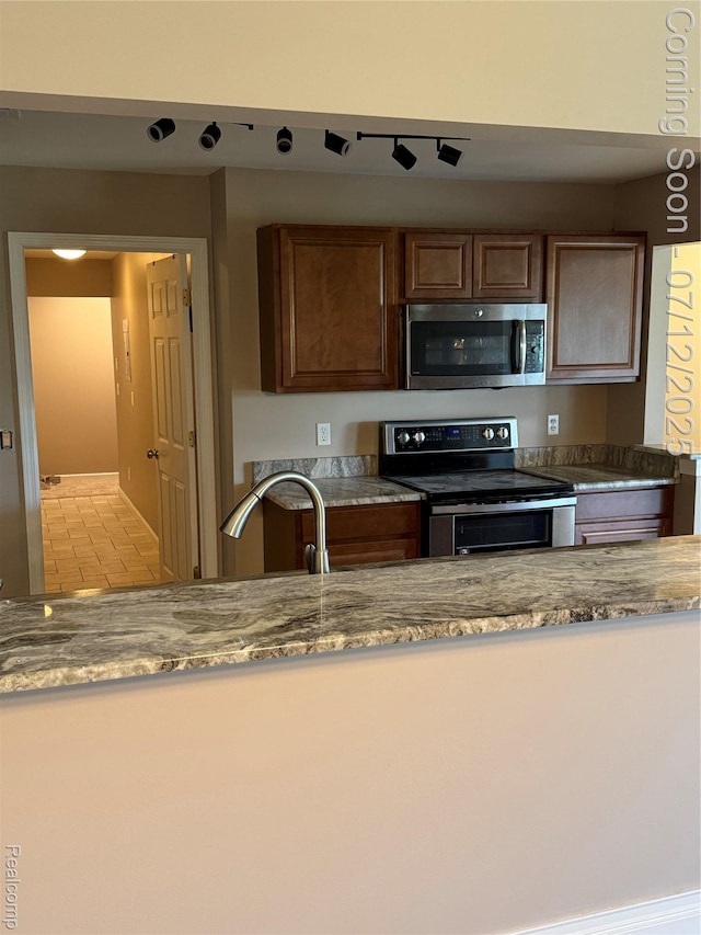 45562 Warwick Dr, Macomb, MI 48044 - kitchen with appliances with stainless steel finishes and stone counters