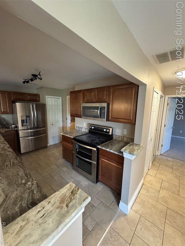 45562 Warwick Dr, Macomb, MI 48044 - kitchen featuring appliances with stainless steel finishes and light stone countertops