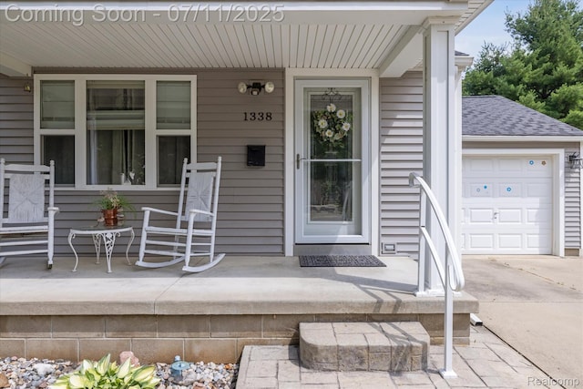 1338 W King St, Owosso, MI 48867 - property entrance with covered porch, a shingled roof, and driveway