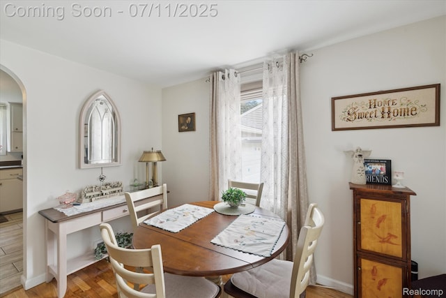 1338 W King St, Owosso, MI 48867 - dining area with arched walkways and light wood-style floors