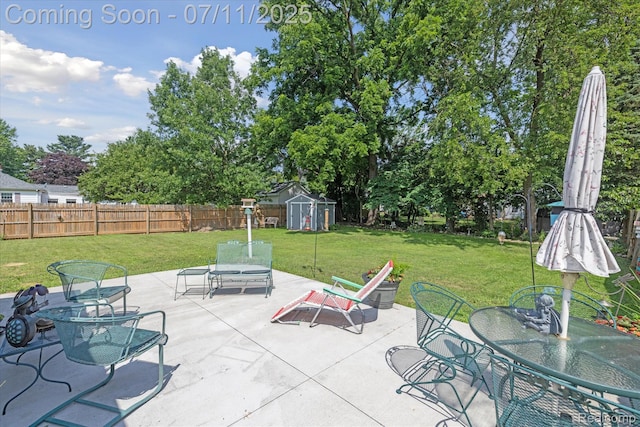 1338 W King St, Owosso, MI 48867 - fenced backyard with outdoor dining space, a storage unit, and a patio area
