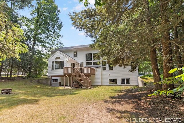 13462 Ravine View Dr, Grand Haven, MI 49417 - rear view of house with stairway, a lawn, a deck, and a fire pit
