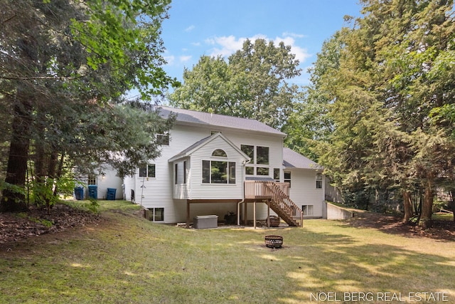 13462 Ravine View Dr, Grand Haven, MI 49417 - back of property featuring stairs, a fire pit, a lawn, and a wooden deck