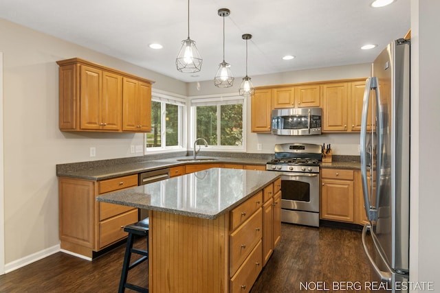 13462 Ravine View Dr, Grand Haven, MI 49417 - kitchen with appliances with stainless steel finishes, dark wood-type flooring, a kitchen island, a kitchen bar, and recessed lighting
