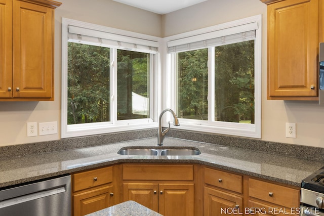 13462 Ravine View Dr, Grand Haven, MI 49417 - kitchen with dishwasher, healthy amount of natural light, dark stone countertops, and brown cabinets