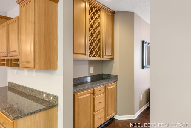13462 Ravine View Dr, Grand Haven, MI 49417 - kitchen featuring dark wood-type flooring and dark stone countertops