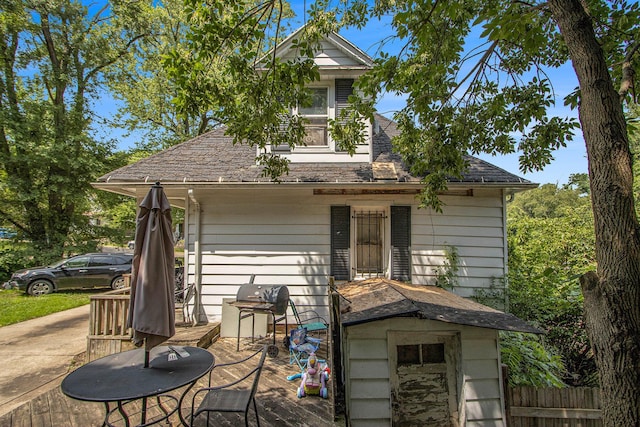 54 Wren St, Battle Creek, MI 49017 - rear view of property with a wooden deck and a shingled roof