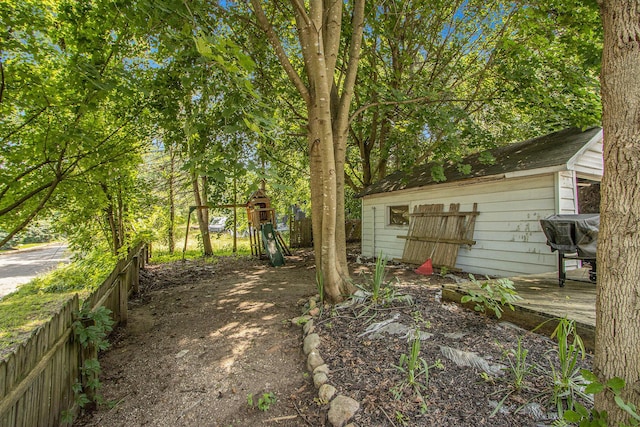 54 Wren St, Battle Creek, MI 49017 - view of yard featuring an outbuilding and a deck