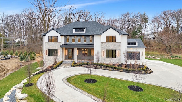 4627 Cimarron Dr, Bloomfield Hills, MI 48302 - modern farmhouse style home with curved driveway, stone siding, covered porch, a front lawn, and a garage