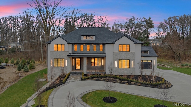 4627 Cimarron Dr, Bloomfield Hills, MI 48302 - modern farmhouse featuring curved driveway, a porch, stucco siding, a garage, and a yard
