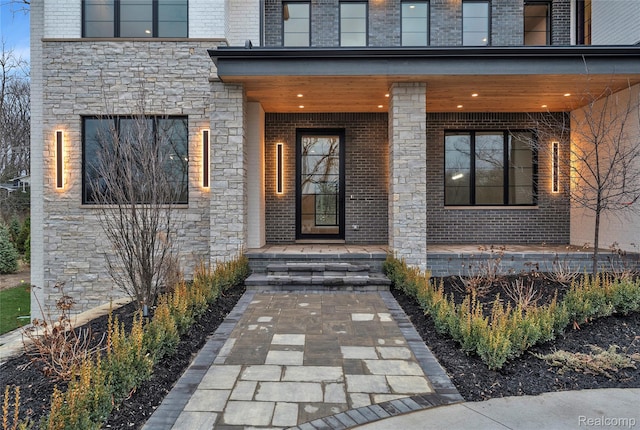 4627 Cimarron Dr, Bloomfield Hills, MI 48302 - entrance to property featuring stone siding, a porch, and brick siding