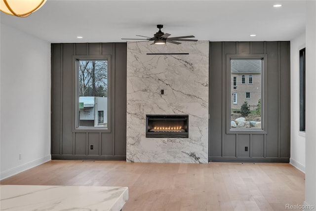 4627 Cimarron Dr, Bloomfield Hills, MI 48302 - unfurnished living room with wood finished floors, a high end fireplace, a ceiling fan, and recessed lighting