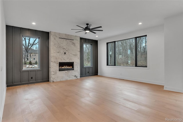 4627 Cimarron Dr, Bloomfield Hills, MI 48302 - unfurnished living room with wood finished floors, a ceiling fan, healthy amount of natural light, a fireplace, and recessed lighting